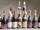 several bottles of wine are lined up in a row on a table