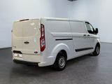 the back of a white van is parked in a large room