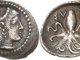 a close up of a coin with an octopus on it