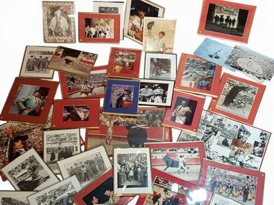 a lot of old photos of people on a table