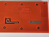 an orange piece of plastic with a metal latch on it
