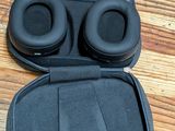an image of a pair of headphones in a case on a wooden floor