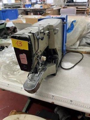 a sewing machine sitting on a table in a factory