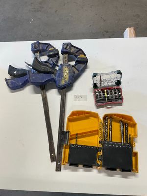 a table with tools on it that include a hammer, pliers, and a pair of pliers