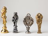 four different types of figurines sitting on top of a white surface