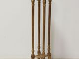 an image of a gold pedestal with a marble top on a white floor