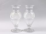 pair of clear glass vases sitting on top of a white table