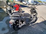 a scooter that is parked on the side of the street