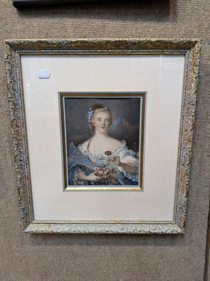 portrait of a woman in a blue dress holding a basket of flowers