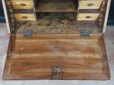 a wooden chest with drawers and a mirror on it