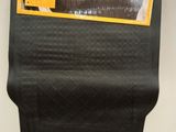 le dos d'un tapis de voiture noir sur lequel est collé un autocollant jaune