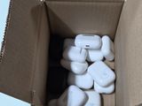 a cardboard box with a bunch of white rocks inside of it