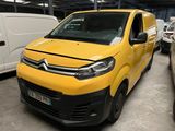 a yellow van parked in a parking lot next to a white van