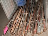 a pile of wooden sticks and a bucket on the ground