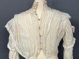 a close up of a mannequin torso with a white blouse on it
