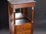 a small wooden cabinet with a mirror on top of it