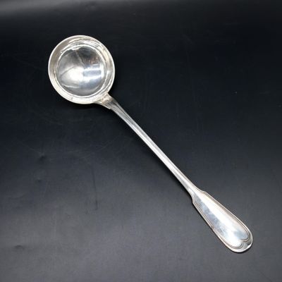 silver spoon on a black surface with a black background