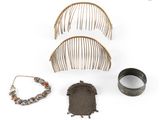 several pieces of jewelry including a comb, bracelet, and ring