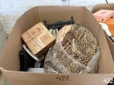 a cardboard box filled with assorted items on the floor