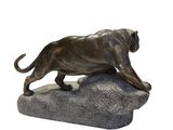 statue of a lion on a rock on a white background
