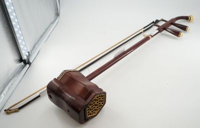 un violon posé par terre à côté d'un miroir