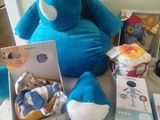 a stuffed elephant that is sitting next to a box of baby items