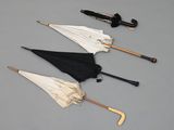 several umbrellas are lined up in a row on a gray surface