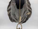 a large bronze sculpture of a shell on a stand on a white background