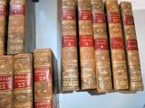 many old books stacked on a shelf in a room