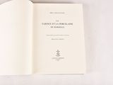an open book on a white surface with a black and white picture