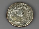 a silver coin with an image of a woman on it