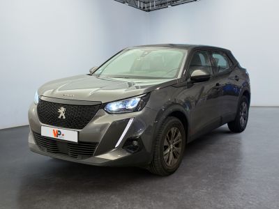 the grey car is parked in a large room with a black floor