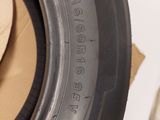 a close up of a tire on a white surface with a cardboard box