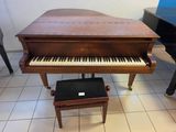 a piano and a stool in a room