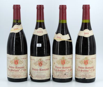 three bottles of wine are lined up on a white surface