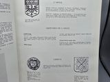 an open book with a picture of a coat of arms on it