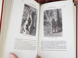a person holding an open book in their hand