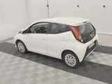 a small white car that is parked in a garage