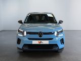 the front view of a blue mercedes suv parked in a showroom