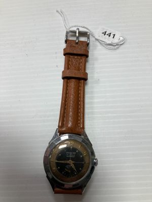 gros plan d'une montre sur une surface blanche avec une étiquette