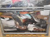 a metal box filled with assorted items on the floor
