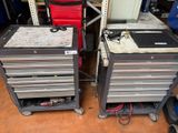 two metal drawers with tools on them in a garage
