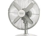a white fan sitting on top of a metal stand