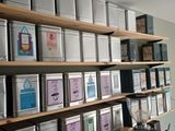 many tins of tea on the shelves in the room