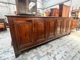 a large wooden cabinet with a mirror on top of it