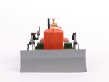 a small toy tractor with a man on top of it