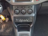 the interior of a car with a steering wheel and dashboard controls