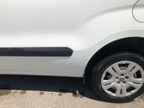 a small white car that is parked in the parking lot