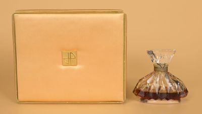 an image of a bottle of perfume sitting next to a box