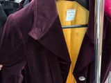 many coats hanging on a rack in a store